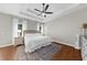 Spacious bedroom with hardwood floors, a ceiling fan, neutral decor, and large windows providing natural light at 7610 Golden Sands Dr, Cumming, GA 30041