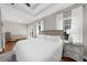 Bright bedroom boasts hardwood floors, a tray ceiling, neutral walls, and large windows for ample natural light at 7610 Golden Sands Dr, Cumming, GA 30041