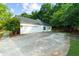Spacious two-car garage and driveway surrounded by mature trees at 7610 Golden Sands Dr, Cumming, GA 30041
