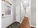 Inviting hallway with wood floors, white door and trim, and ample natural light from the front entrance at 7610 Golden Sands Dr, Cumming, GA 30041