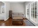 Bright sitting area with hardwood floors, a cozy couch, and French doors offering natural light at 7610 Golden Sands Dr, Cumming, GA 30041