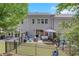 Expansive view of the fenced backyard with a well-manicured lawn, patio area and exterior of the home at 146 Bellehaven Dr, Woodstock, GA 30188