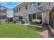 A serene backyard with a black fenced yard, green lawn and a patio furnished with outdoor furniture at 146 Bellehaven Dr, Woodstock, GA 30188