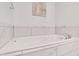 Close up of white tiled bathtub with a white tub and silver fixtures at 146 Bellehaven Dr, Woodstock, GA 30188