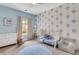 Charming bedroom with hot air balloon themed wallpaper, white furniture, and a cozy armchair at 146 Bellehaven Dr, Woodstock, GA 30188