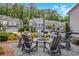 Community fire pit area with outdoor seating and landscaping in front of townhome community at 146 Bellehaven Dr, Woodstock, GA 30188