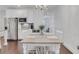 Bright dining area featuring a wooden table, white chairs, and elegant chandelier at 146 Bellehaven Dr, Woodstock, GA 30188