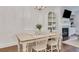 Bright dining area featuring a wooden table, white chairs, and elegant chandelier at 146 Bellehaven Dr, Woodstock, GA 30188