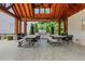 Outdoor grilling area featuring a stainless steel grill, seating and dining area under a covered pavilion at 146 Bellehaven Dr, Woodstock, GA 30188