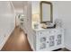 Elegant hallway featuring dark wood floors, white console table, and decorative mirror at 146 Bellehaven Dr, Woodstock, GA 30188