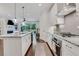 Bright eat-in kitchen featuring stainless appliances, granite countertops, and a large center island at 146 Bellehaven Dr, Woodstock, GA 30188
