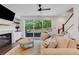Cozy living room with a fireplace, large windows, and access to the patio at 146 Bellehaven Dr, Woodstock, GA 30188