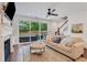 Cozy living room with a fireplace, large windows, and access to the patio at 146 Bellehaven Dr, Woodstock, GA 30188