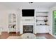 Bright living room boasts a fireplace with TV, shelving, and neutral decor, perfect for relaxation at 146 Bellehaven Dr, Woodstock, GA 30188