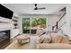 Cozy living room with a fireplace, large windows, and access to the patio at 146 Bellehaven Dr, Woodstock, GA 30188