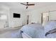 Spacious main bedroom featuring a TV, dresser, chair, and stylish decor at 146 Bellehaven Dr, Woodstock, GA 30188