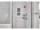 Modern shower featuring white tiled walls, a showerhead, and built-in shelves at 146 Bellehaven Dr, Woodstock, GA 30188
