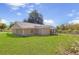 Spacious backyard featuring green lawn, and a screened porch at 3556 Riley Rd, Douglasville, GA 30134