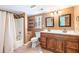 Bathroom featuring a double vanity, bath tub, and wood accents at 3556 Riley Rd, Douglasville, GA 30134