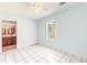 Bedroom featuring white tile floors, ceiling fan, and view into bathroom at 3556 Riley Rd, Douglasville, GA 30134