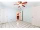 Bedroom featuring a ceiling fan, tile flooring, and access to a bathroom at 3556 Riley Rd, Douglasville, GA 30134