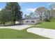Inviting single-story home featuring lush greenery, a neatly kept lawn, and a concrete driveway at 3556 Riley Rd, Douglasville, GA 30134