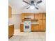 Functional kitchen featuring tile floors, wooden cabinets, and appliances ready for culinary adventures at 3556 Riley Rd, Douglasville, GA 30134