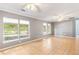 Bright living room featuring tile floors, multiple windows, and ceiling fans at 3556 Riley Rd, Douglasville, GA 30134