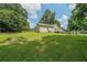 Large, well-maintained backyard featuring a deck, green lawn and mature trees at 58 Bisbee Se Ave, Atlanta, GA 30315