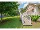 View of the backyard with a deck and ramp, surrounded by lush greenery and trees at 58 Bisbee Se Ave, Atlanta, GA 30315