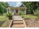 Charming home with a welcoming porch, landscaped front yard, and inviting red front door at 58 Bisbee Se Ave, Atlanta, GA 30315