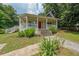 Inviting home with a charming front porch, complemented by lush greenery in the front yard at 58 Bisbee Se Ave, Atlanta, GA 30315