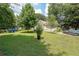 Well-maintained front yard with lush green grass, mature trees, and driveway at 58 Bisbee Se Ave, Atlanta, GA 30315