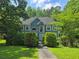 Charming two-story home with a well-manicured lawn and lush greenery providing a sense of privacy at 6797 Lombard Ct, Lithonia, GA 30058