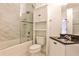 Bathroom with tile shower, toilet and sink with black granite countertop and storage cabinet at 791 Wylie Se St # 404, Atlanta, GA 30316
