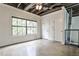 Bedroom with a ceiling fan, large window, and exposed duct work, providing a modern aesthetic at 791 Wylie Se St # 404, Atlanta, GA 30316
