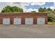Image showcases four individual white garages each labeled with unit numbers, set in a brick building at 791 Wylie Se St # 404, Atlanta, GA 30316