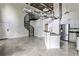 Open-concept living space with spiral staircase, concrete floors, and high ceilings at 791 Wylie Se St # 404, Atlanta, GA 30316