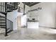 Bright open-concept floor plan with kitchen, stainless appliances, and spiral staircase at 791 Wylie Se St # 404, Atlanta, GA 30316