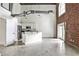Open-concept living area with exposed brick, tall ceilings, and a modern kitchen at 791 Wylie Se St # 404, Atlanta, GA 30316