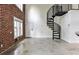 Loft living area with exposed brick wall and industrial spiral staircase at 791 Wylie Se St # 404, Atlanta, GA 30316