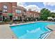Wide shot of a community swimming pool with lounge seating and brick apartment buildings in the background at 791 Wylie Se St # 404, Atlanta, GA 30316