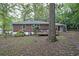 Cozy backyard with brick home, wooden deck, and lush green trees offering a private outdoor space at 1327 Rupert Rd, Decatur, GA 30030