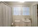 Bathroom features a white vanity, toilet, and shower with a light gray curtain at 1327 Rupert Rd, Decatur, GA 30030