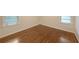 Bright bedroom with hardwood floors and two windows letting in natural light at 1327 Rupert Rd, Decatur, GA 30030