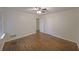 This is a spacious bedroom with hardwood floors and a ceiling fan at 1327 Rupert Rd, Decatur, GA 30030