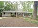 Charming brick home featuring a well-maintained front yard with mature trees and a cozy, inviting exterior at 1327 Rupert Rd, Decatur, GA 30030