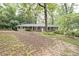 Charming brick home featuring a well-maintained front yard with mature trees and a cozy, inviting exterior at 1327 Rupert Rd, Decatur, GA 30030