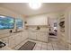 Bright kitchen featuring white cabinets, tile flooring, and ample counter space for culinary creations at 1327 Rupert Rd, Decatur, GA 30030