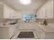 Bright kitchen featuring white cabinets, tile flooring, and ample counter space for culinary creations at 1327 Rupert Rd, Decatur, GA 30030
